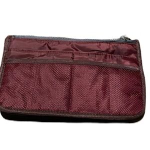Travel maroon toiletry bag. 10” long by 6” tall.